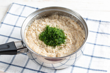 Barley porridge with dill in a saucepan. Recipe step by step