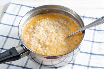 Barley porridge with eggs in a saucepan. Recipe step by step