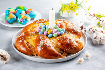 Portuguese traditional Easter cake. Folar with eggs on wooden table.
