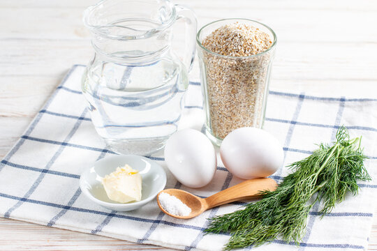Ingredients for cooking barley porridge with egg and dill.