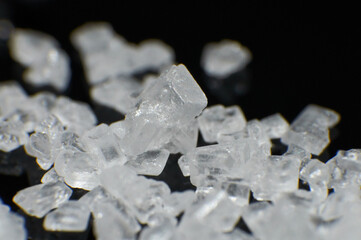 White crystals on a black background.