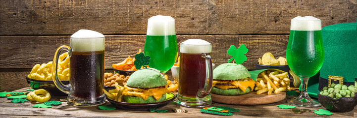 St Patrick`s holiday party invitation, bar menu background. Irish St Patrick`s day beer, ale glasses, snacks, appetizer, green burger, wooden bar table with shamrock, clover, coins, leprechaun hat  - obrazy, fototapety, plakaty