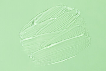 Smear of transparent cosmetic gel on mint background.Copy space for text,mockup concept.