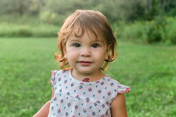 Cute Toddler Girl outdoors with a strawberry hemangioma nevus birthmark on her neck