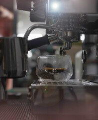 Glass of coffee put on machine,Lens flare effec