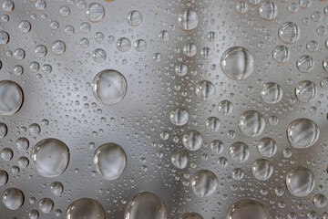 Water droplets on glasss as background
