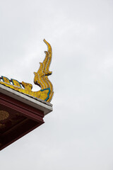 Fototapeta na wymiar Thai traditional statue on the roof of Temple