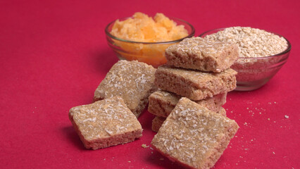 Indian makar sankranti festival food or sweets. Tilgul in a small bowl. Tilgul is made out of sesame seeds, peanuts, and jaggery. Til gud chikki or sesame candy. Copy Space.
