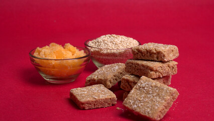 Indian makar sankranti festival food or sweets. Tilgul in a small bowl. Tilgul is made out of sesame seeds, peanuts, and jaggery. Til gud chikki or sesame candy. Copy Space.