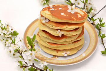 mouth-watering pancakes and a plum blossom branch nearby