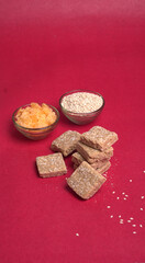Indian makar sankranti festival food or sweets. Tilgul in a small bowl. Tilgul is made out of sesame seeds, peanuts, and jaggery. Til gud chikki or sesame candy. Copy Space.