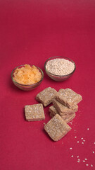 Indian makar sankranti festival food or sweets. Tilgul in a small bowl. Tilgul is made out of sesame seeds, peanuts, and jaggery. Til gud chikki or sesame candy. Copy Space.