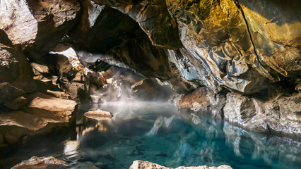 Grjotagja volcanic hot springs cave, near Reykjahlid, Myvatn, Iceland, with blue and transparent water.