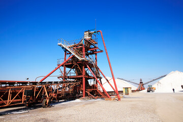 Fototapeta na wymiar Salt production.  machinery for the treatment of the salt, The equipment and salt stock of a salt plant