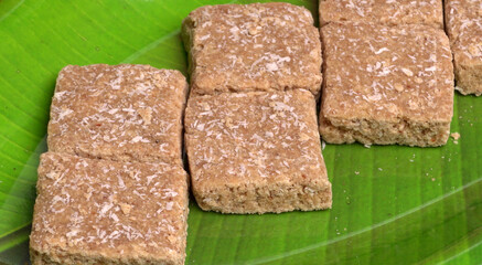 Indian makar sankranti festival food or sweets. Tilgul in a small bowl. Tilgul is made out of sesame seeds, peanuts, and jaggery. Til gud chikki or sesame candy. Copy Space.