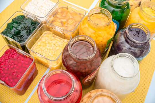 Ingredients in making Halo-halo, a popular cold dessert in the Philippines - Gulaman, corn, kaong, gulaman, jackfruit, beans, pinipig, etc.