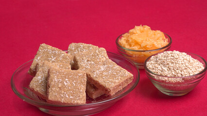 Indian makar sankranti festival food or sweets. Tilgul in a small bowl. Tilgul is made out of sesame seeds, peanuts, and jaggery. Til gud chikki or sesame candy. Copy Space.