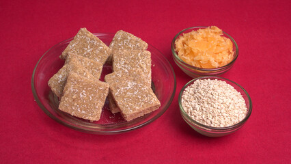 Indian makar sankranti festival food or sweets. Tilgul in a small bowl. Tilgul is made out of sesame seeds, peanuts, and jaggery. Til gud chikki or sesame candy. Copy Space.