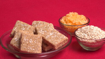 Indian makar sankranti festival food or sweets. Tilgul in a small bowl. Tilgul is made out of sesame seeds, peanuts, and jaggery. Til gud chikki or sesame candy. Copy Space.