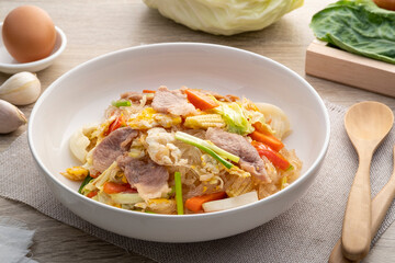 Thai Stir-fried Glass Noodles (Pad Woonsen),Fried cellophane noodle with pork and vegetable in white plate,traditional Thai noodle dish
