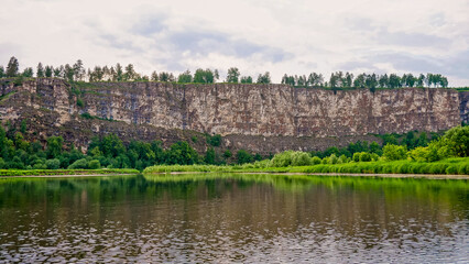 Fototapeta na wymiar Rafting on the Ural River along steep cliffs.