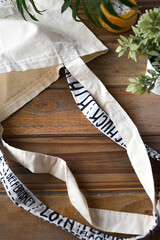 reusable shopping bag on wooden background with plants and candle