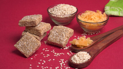 Indian makar sankranti festival food or sweets. Tilgul in a small bowl. Tilgul is made out of sesame seeds, peanuts, and jaggery. Til gud chikki or sesame candy. Copy Space.