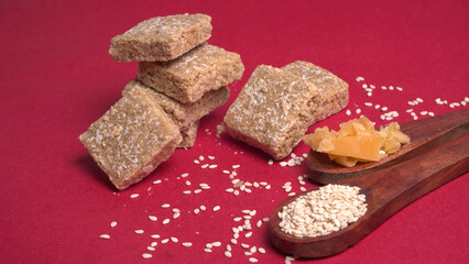 Indian makar sankranti festival food or sweets. Tilgul in a small bowl. Tilgul is made out of sesame seeds, peanuts, and jaggery. Til gud chikki or sesame candy. Copy Space.