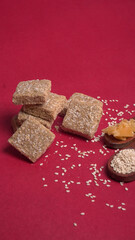 Indian makar sankranti festival food or sweets. Tilgul in a small bowl. Tilgul is made out of sesame seeds, peanuts, and jaggery. Til gud chikki or sesame candy. Copy Space.
