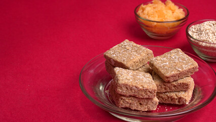Indian makar sankranti festival food or sweets. Tilgul in a small bowl. Tilgul is made out of sesame seeds, peanuts, and jaggery. Til gud chikki or sesame candy. Copy Space.