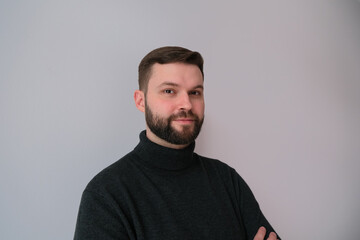 lifestyle portrait of a man in black on monochrome background