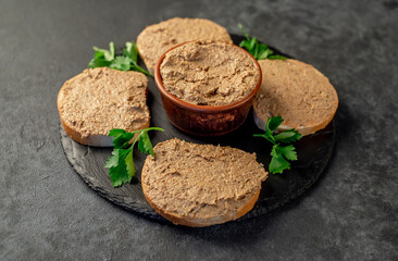 Toasts with beef and pork pate on stone background