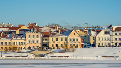Obraz premium Panoramic view of old building in historical center of Minsk. Historical building near the frozen river.
