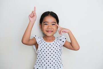 Asian kid smiling while pointing up and her brain. Smart concept