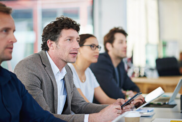 Lets clarify this.... Cropped shot of business people around a table in a meeting.