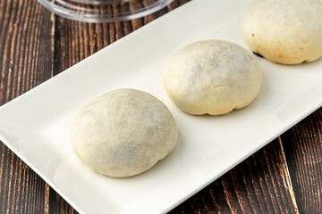 Delicious izmir bomb or izmir bombasi on a white plate on wooden table
