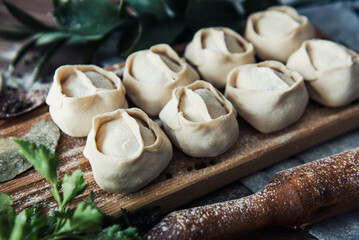 Manti on a wooden tray with a green twig