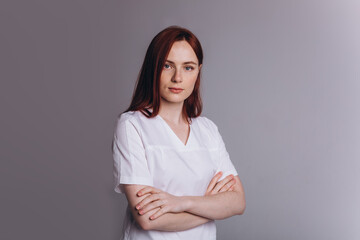 Fototapeta premium Medicine personal in uniform. Young woman doctor in clinic. Health care concept
