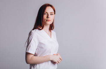 Fototapeta premium Medicine personal in uniform. Young woman doctor in clinic. Health care concept