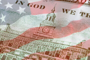 Independence Hall on back side 100 dollars banknote with american flag background. 100. Economy, savings and the US dollar.