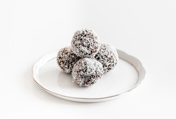 Coconut balls on a white Herend porcelain plate.