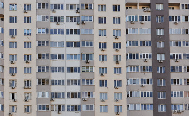 Fototapeta na wymiar Residential high-rise windows and balconies. Exterior of modern high-rise residential buildings. 