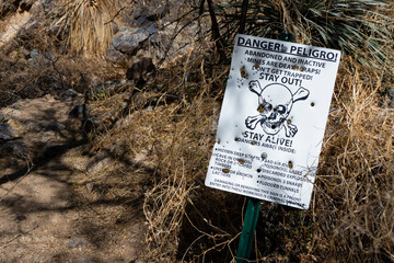Government warning sign at the entrance to an abandoned mine shaft