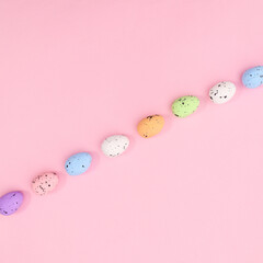 Neatly layout of Easter colorful eggs on pastel bright pink background. Flat lay Spring holidays concept.