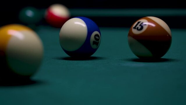 Billiard balls on a table covered with green cloth, 4k video