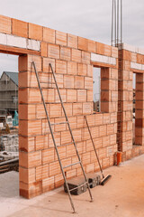 Construction industry details - industrial bricklayer installing bricks on construction site..