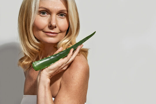 Confident Mature Woman Hold Aloe Vera Green Leaf