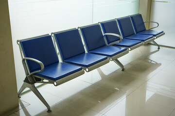 Blue chairs lined up in the public service room in government.