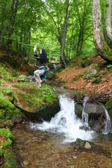 yoga pose in the forest near the stream..