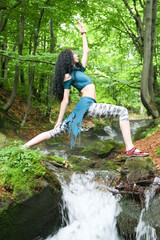 yoga pose in the forest near the stream..